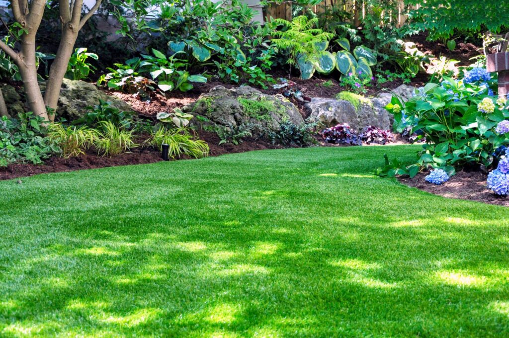 Grüne Gartenpflanzen mit Gartendeko Metall